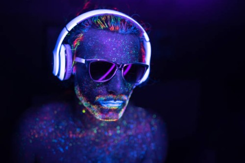 man painted in fluorescent uv colors with sunglasses and headset - fashion stock pictures, royalty-free photos & images