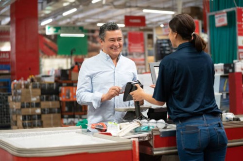 man paying by card at the cashier at a home improvement store - home decoration stock pictures, royalty-free photos & images