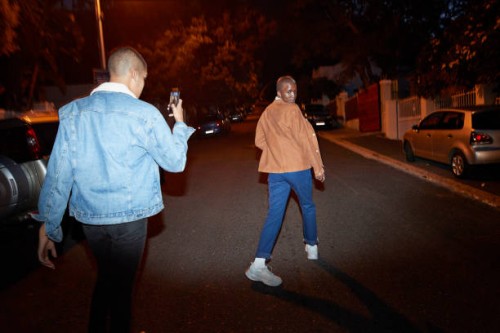 man photographing friend on smart phone at street - fashion stock pictures, royalty-free photos & images