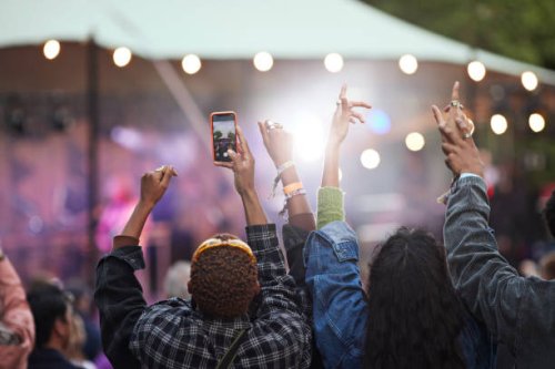 man photographing through smart phone with friends - concert stock pictures, royalty-free photos & images