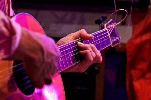 man playing an acoustic guitar on stage - concert stock pictures, royalty-free photos & images