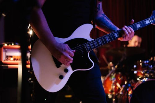 man playing electric guitar on the stage at the rock concert - concert stock pictures, royalty-free photos & images