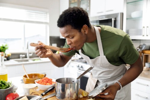 man preparing dinner in kitchen - food stock pictures, royalty-free photos & images
