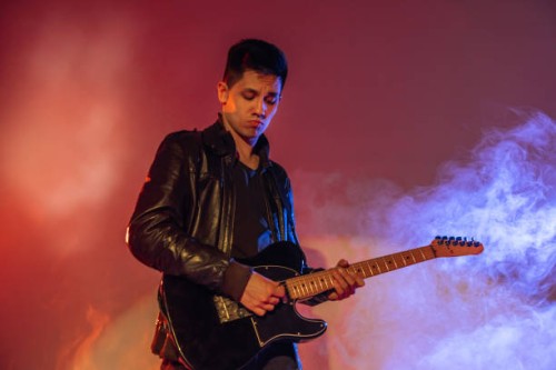 man rock musician playing electric guitar - concert stock pictures, royalty-free photos & images