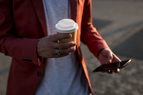 man's hand holding coffee to go - junk food stock pictures, royalty-free photos & images