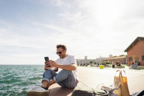 man sitting on the pier - travel stock pictures, royalty-free photos & images