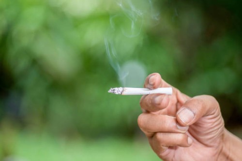 man smoking a cigarette - junk food stockfoto's en -beelden
