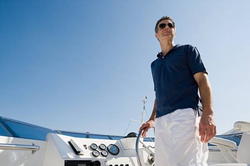 man steering a yacht - fashion stock pictures, royalty-free photos & images