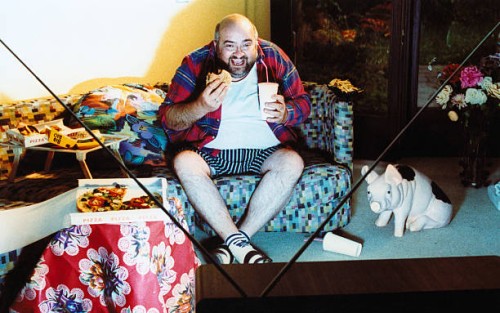 man watching tv and eating junk food - junk food stock pictures, royalty-free photos & images