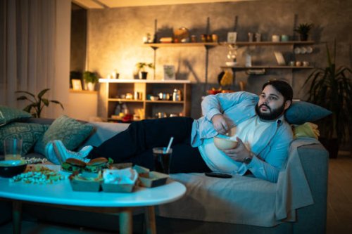 man watching tv show - junk food stock pictures, royalty-free photos & images