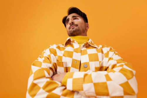 man wearing checked shirt standing with arms crossed - fashion stock pictures, royalty-free photos & images