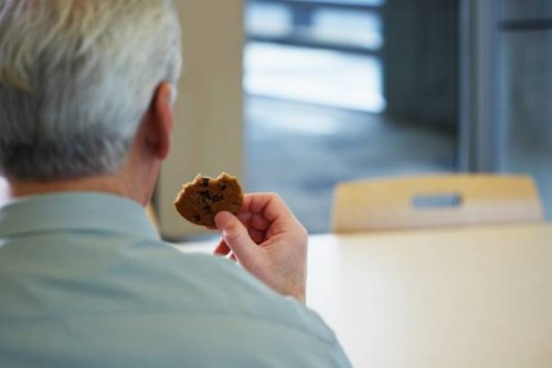 man with a cookie - junk food stock pictures, royalty-free photos & images