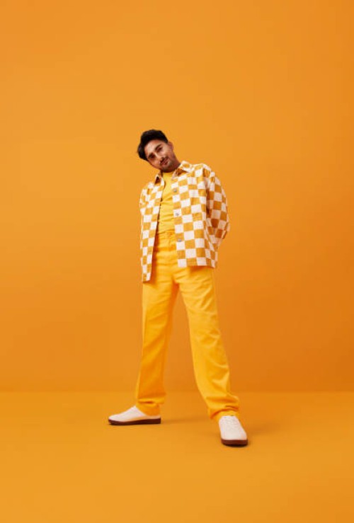 man with vitiligo standing with hands behind back - fashion stock pictures, royalty-free photos & images