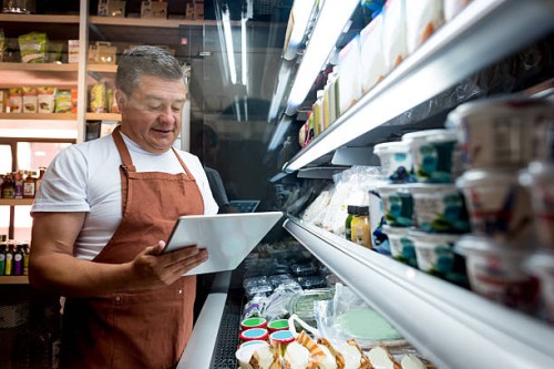 man working at a grocery store - food stock pictures, royalty-free photos & images