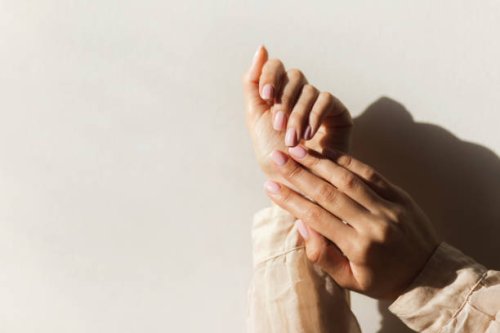 manicure on female hands with light pink nail polish. - nails art stock pictures, royalty-free photos & images