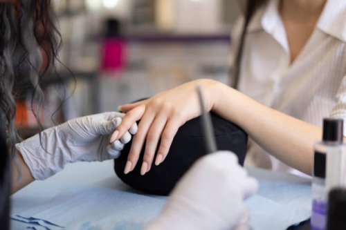 manicurist applying acrylic on nails - nails art stock pictures, royalty-free photos & images