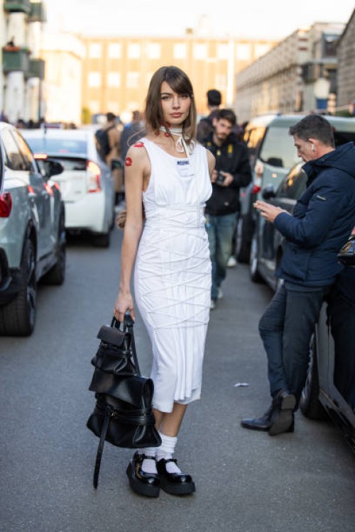Mara Lafontan wears white dress, black bag outside Moschino during the Milan Fashion Week Womenswear Fall/Winter 2025/2026 on February 28, 2025 in...