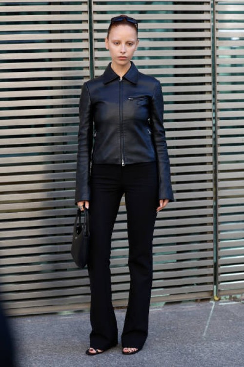 Marie Gaguech wears black leather Courrèges jacket, black trousers, black Courrèges bag, outside Courrèges, during the Womenswear Fall/Winter...