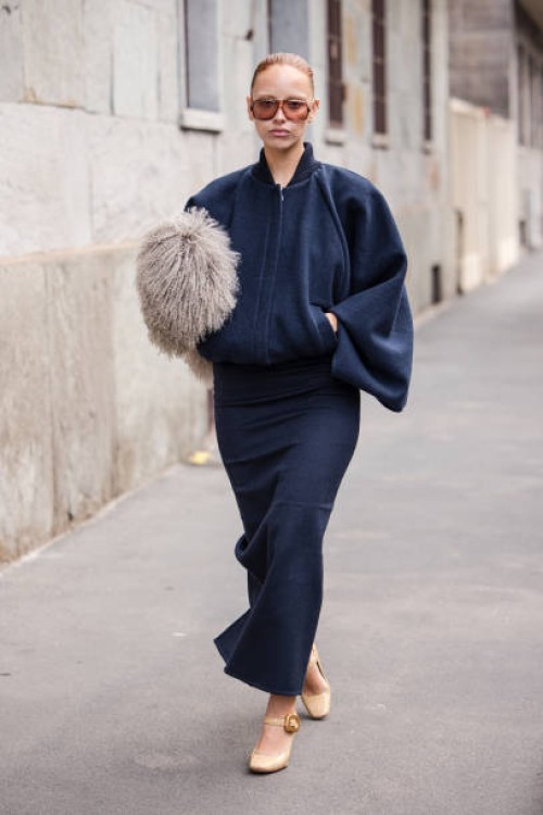 Marie Gaguech wears blue bomber jacket, blue pencil maxi skirt, taupe fur pouch bag, cream mary jane heels, outside Max Mara, during the Milan...