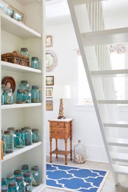 mason jars arranged on shelves in living room at cottage - home decoration stock pictures, royalty-free photos & images