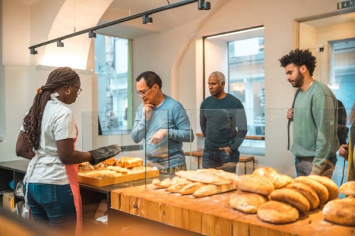 mature asian buying freshly baked goods in a bakery - junk food stock pictures, royalty-free photos & images