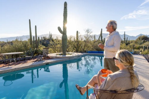 mature couple relax at desert swimming pool - travel stock pictures, royalty-free photos & images