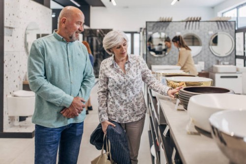 mature couple shopping for bathroom equipment - home decoration stock pictures, royalty-free photos & images