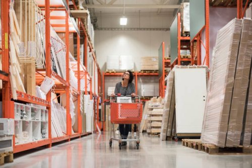mature female customer looking up while pushing shopping cart in hardware store - home decoration stock pictures, royalty-free photos & images