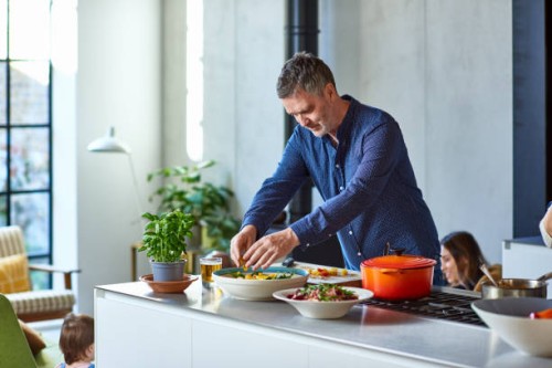 mature man preparing healthy meal on kitchen counter - food stock pictures, royalty-free photos & images