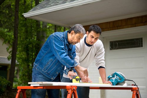 mature man working with son - home decoration stock pictures, royalty-free photos & images