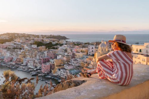 mature woman admiring procida sunset cityscape - travel stock pictures, royalty-free photos & images