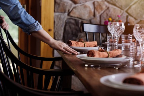 mature woman arranging dinner table at home - home decoration stock pictures, royalty-free photos & images