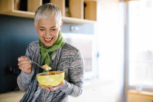 mature woman having healthy breakfast - food stock pictures, royalty-free photos & images