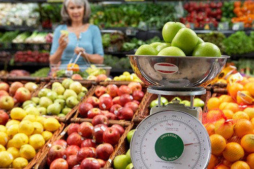 "mature woman in supermarket, focus on weighing scale" - food stock pictures, royalty-free photos & images