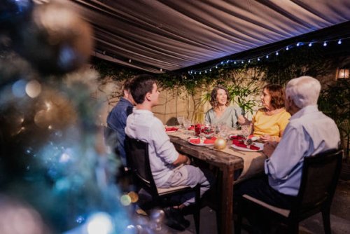 mature woman talking with her family at christmas dinner - garden decoration stock pictures, royalty-free photos & images