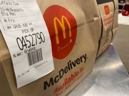 McDelivery Pick up food order bags at McDonald's fast food restaurant, Queens, New York.