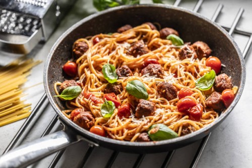meatballs with spaghettis tomato sauce in a pan. italian pasta with beef balls in tomato sauce, parmesan and basil. - food stock pictures, royalty-free photos & images