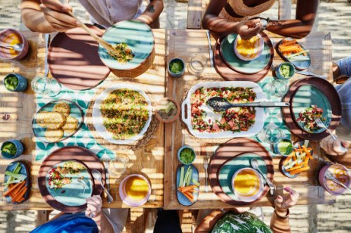 medium overhead shot of friends sharing lunch at outdoor table - food stock pictures, royalty-free photos & images