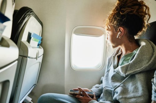 medium shot of girl looking out window of commercial airplane - travel stock pictures, royalty-free photos & images