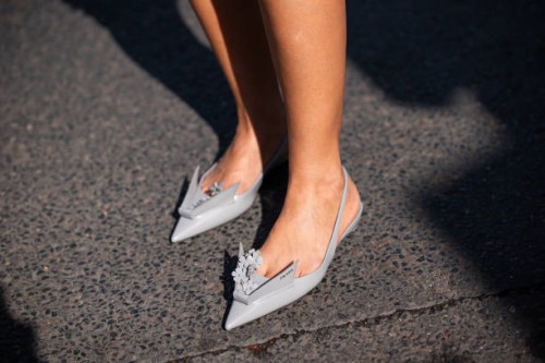 Mehrnaz Ansari wears grey Prada kitten heels, outside Miu Miu, during the Womenswear Spring/Summer 2024 as part of Paris Fashion Week on October 03,...
