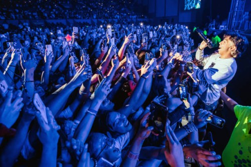 Member of Latin Mafia band performs with the crowd during a concert at Auditorio Citibanamex on September 10, 2023 in Monterrey, Mexico.