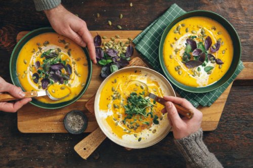 men eating vegan creamy roasted pumpkin soup - food stock pictures, royalty-free photos & images