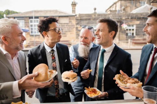 men enjoying food from a food truck - junk food stock pictures, royalty-free photos & images