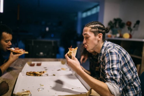 men enjoying pizza - junk food stock pictures, royalty-free photos & images
