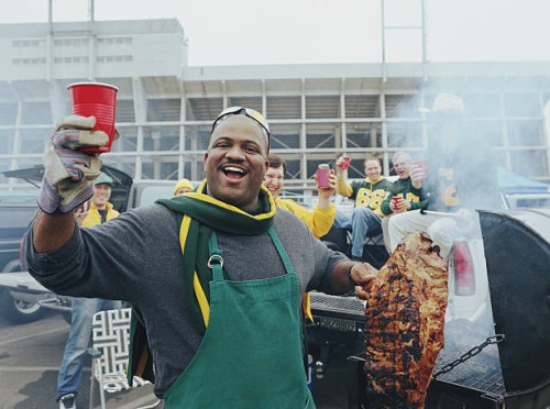 men having barbeque at tailgate party in stadium parking lot - food stock pictures, royalty-free photos & images
