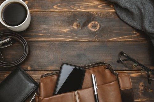 men's satchel bags, mobile phone and male personal belongings on rustic wood - fashion stock pictures, royalty-free photos & images