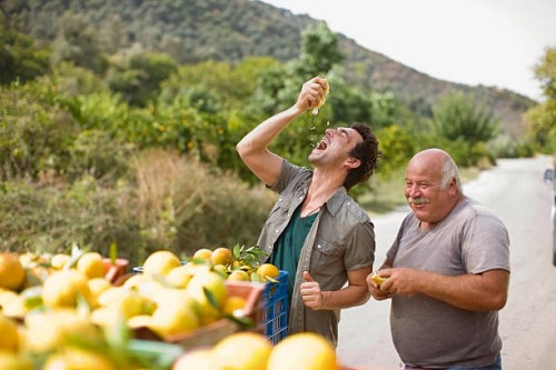 men squashing oranges - food stock pictures, royalty-free photos & images