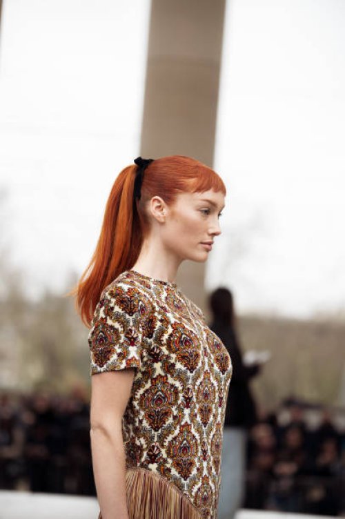 Meredith Duxbury wears a colourful dress with ornaments and tassels outside Rabanne during the Womenswear Fall/Winter 2024/2025 as part of Paris...