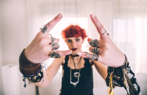 metal girl showing devil horns gesture - fashion stock pictures, royalty-free photos & images