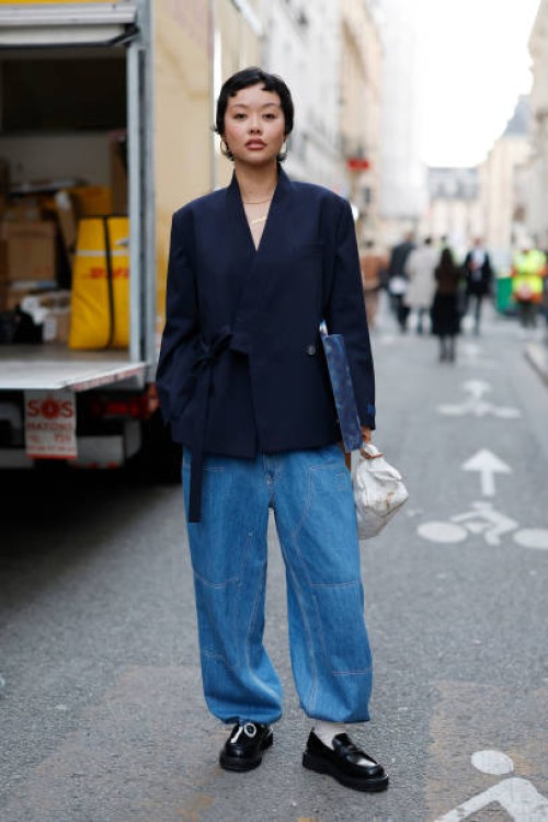 Mia Kong wears blue blazer, light blue baggy jeans, black loafers, outside Kenzo, during the Womenswear Fall/Winter 2025/2026 as part of Paris...
